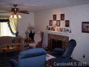 104 Hunters Trail Mill Spring Tryon, NC 28782 - Photo 4 of 4 a living room with furniture and a fireplace