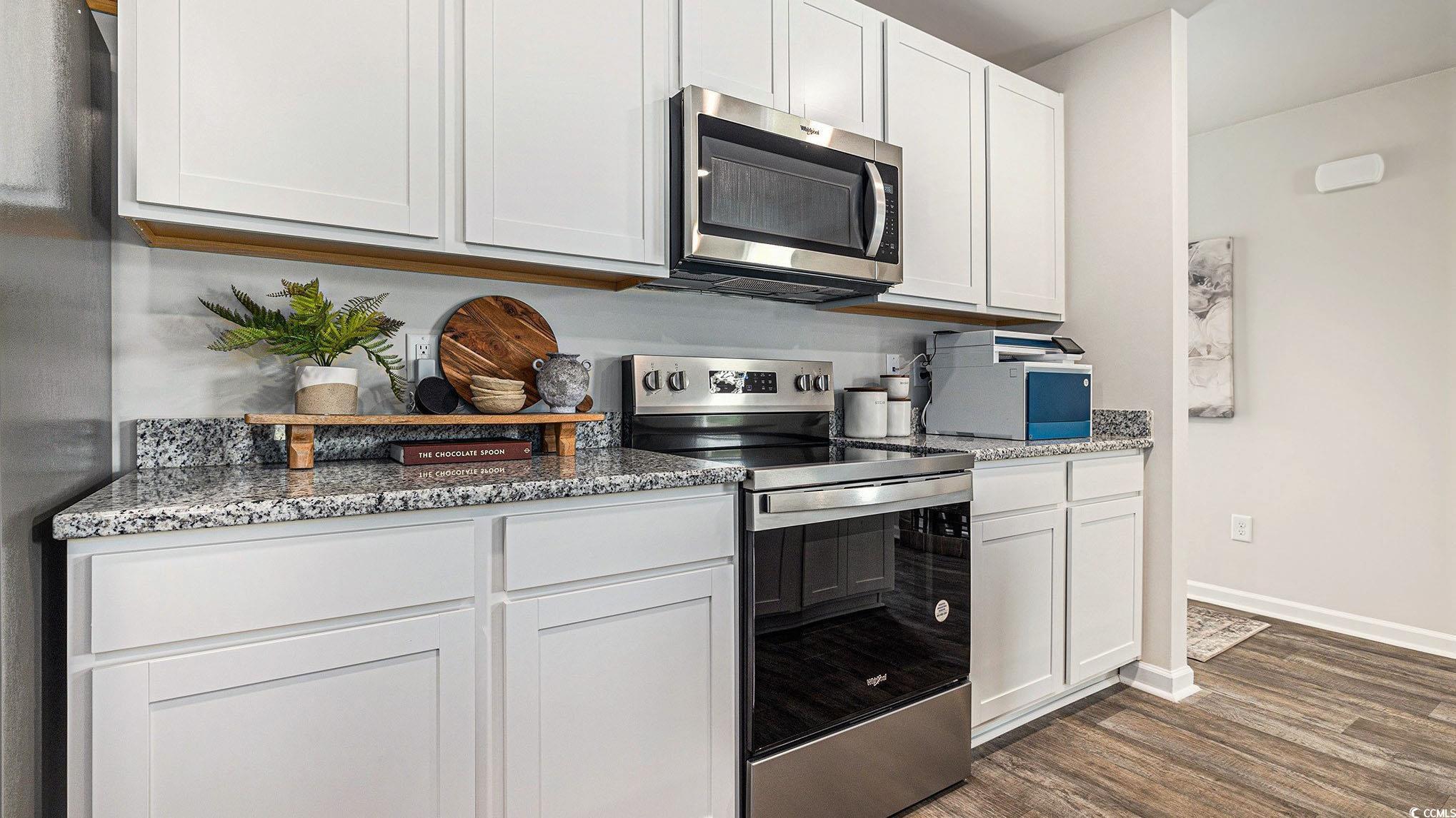 3579 Ashridge Way Conway, SC 29526 - Photo 11 of 27 Kitchen with stainless steel appliances, dark wood-type flooring, baseboards, white cabinets, and light stone counters