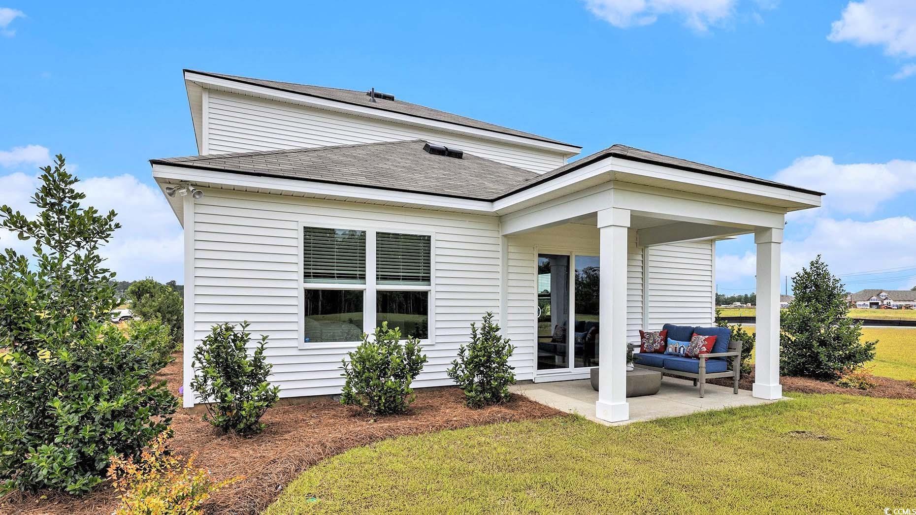 3579 Ashridge Way Conway, SC 29526 - Photo 25 of 27 Rear view of property featuring a lawn, a patio area, an outdoor living space, and a shingled roof