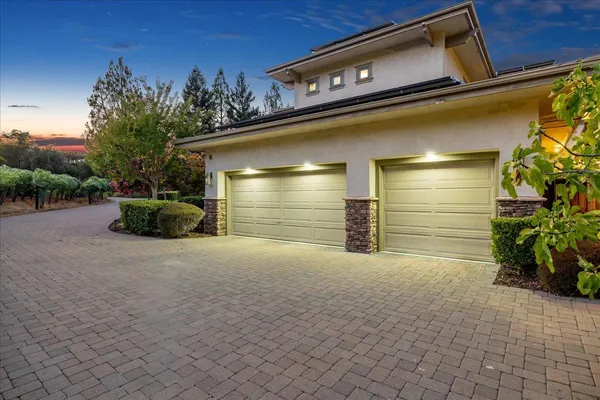 a view of a patio with a table chairs and a backyard