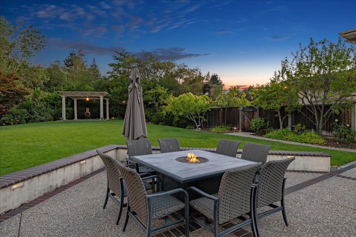20040 Spaich Court Saratoga, CA 95070 - Photo 20 of 87 a view of a patio with a table chairs and a backyard