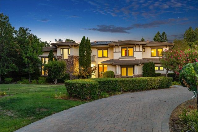 an aerial view of a house with garden space and lake view