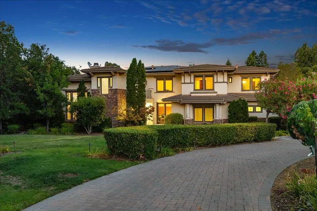 an aerial view of a house with garden space and lake view