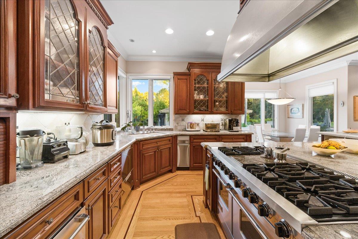 20040 Spaich Court Saratoga, CA 95070 - Photo 31 of 87 a kitchen with stainless steel appliances granite countertop a stove and a sink