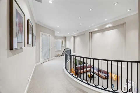 a front view of a house with a yard and fountain in middle of the garden