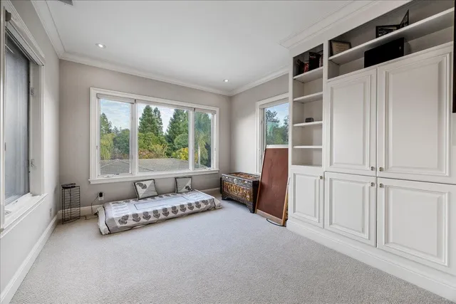 a front view of a house with a yard and potted plants
