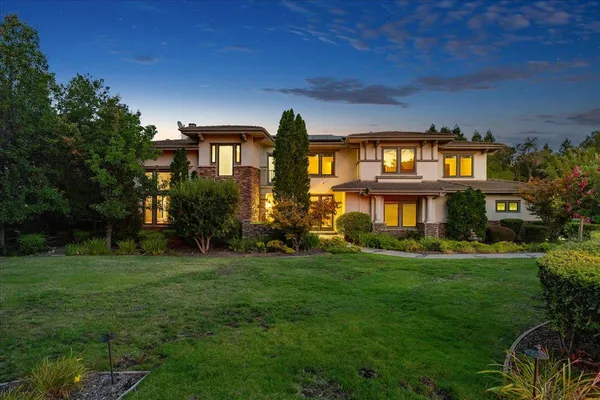 an aerial view of a house with a garden and swimming pool