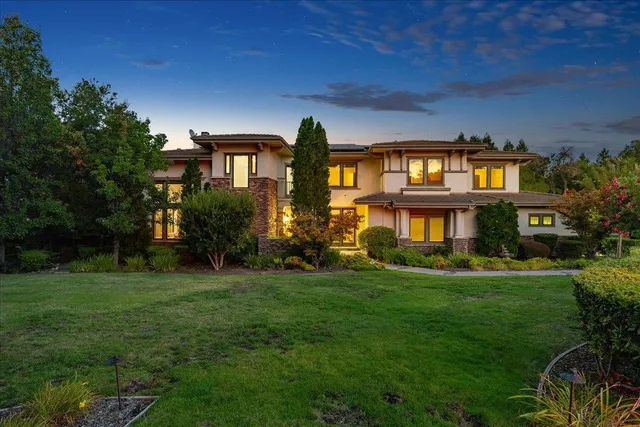 an aerial view of a house with a garden and swimming pool