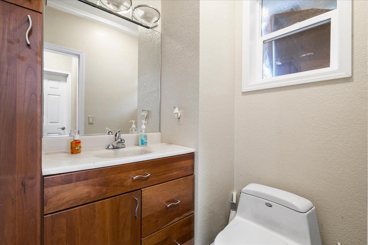 20040 Spaich Court Saratoga, CA 95070 - Photo 45 of 87 a bathroom with a toilet a sink and mirror