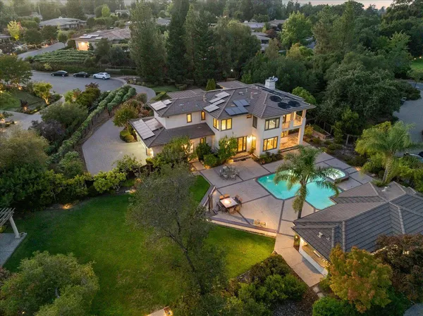 an aerial view of house with yard swimming pool and outdoor seating