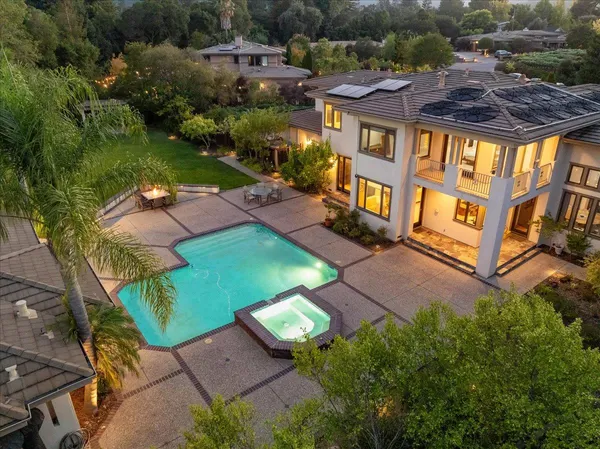 a front view of a house with a yard and fountain