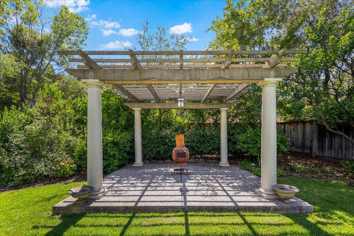 20040 Spaich Court Saratoga, CA 95070 - Photo 82 of 87 a view of a patio with a table chairs and a yard