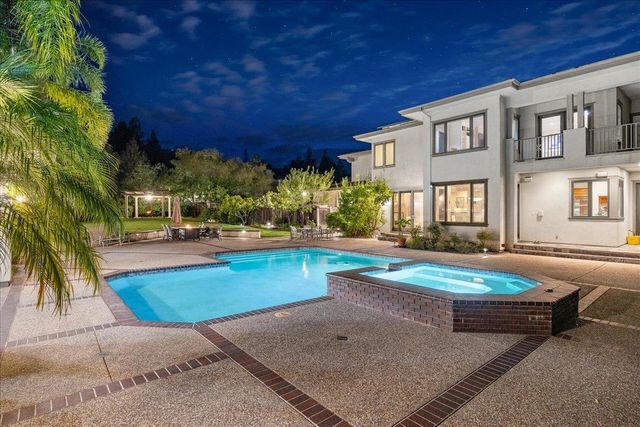 a view of a patio with table and chairs under an umbrella