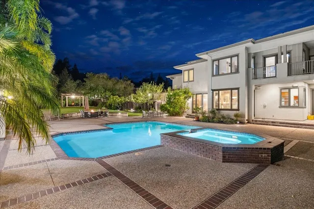 a view of a patio with table and chairs under an umbrella