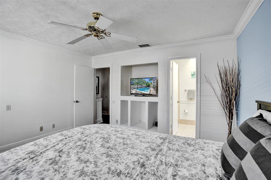 1415 Miami Road, Unit B Fort Lauderdale, FL 33316 - Photo 27 of 59 a bedroom with a bed and a chandelier