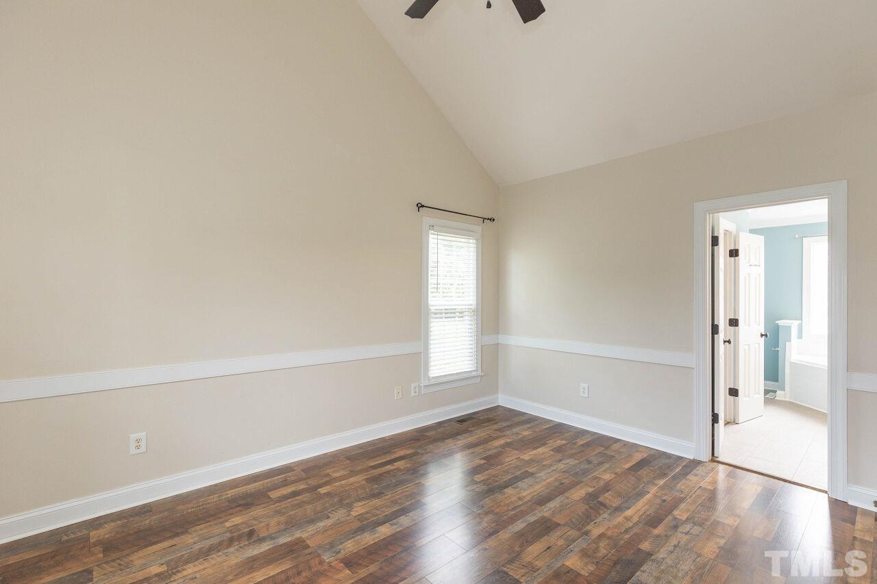 6573 Madison Road Bailey, NC 27807 - Photo 11 of 31 an empty room with wooden floor and windows