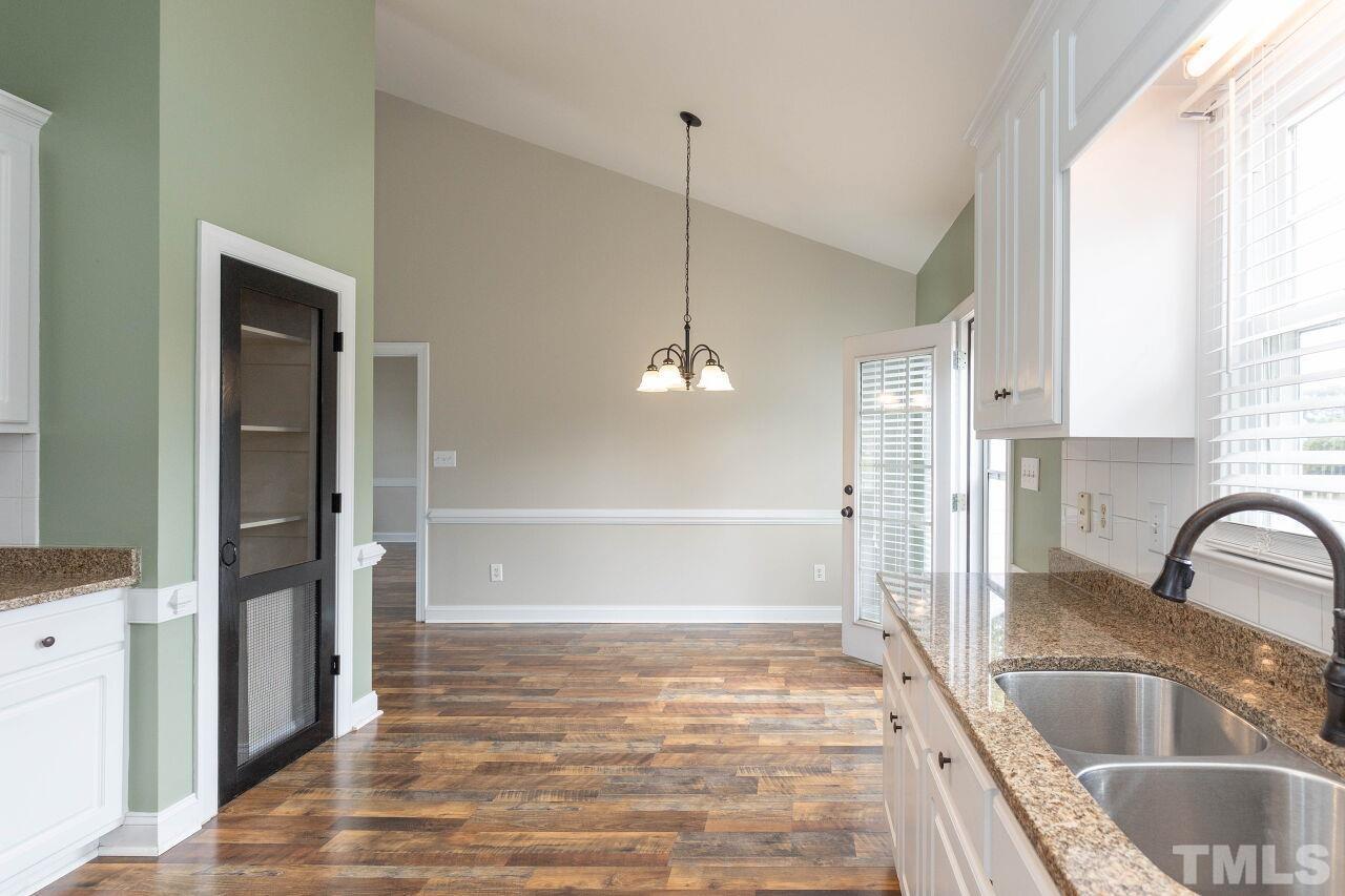 6573 Madison Road Bailey, NC 27807 - Photo 15 of 31 a kitchen with kitchen island a counter top space a sink and stainless steel appliances