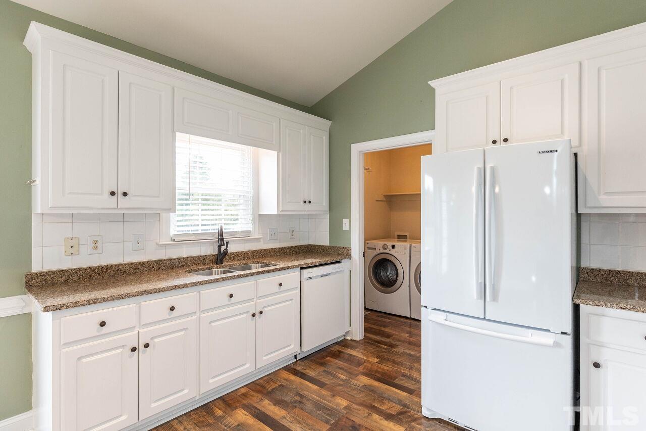 6573 Madison Road Bailey, NC 27807 - Photo 17 of 31 a kitchen with white cabinets and white appliances