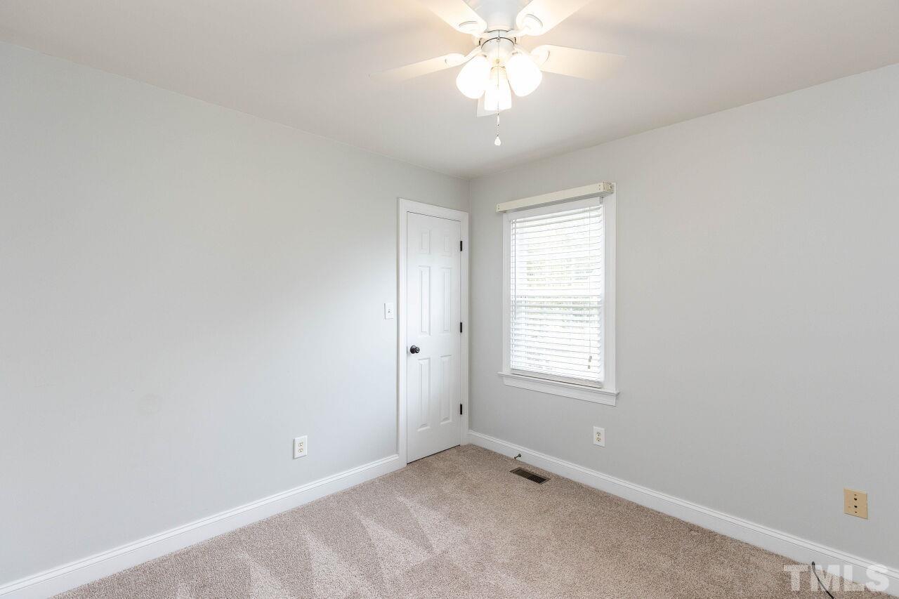 6573 Madison Road Bailey, NC 27807 - Photo 22 of 31 an empty room with windows and fan