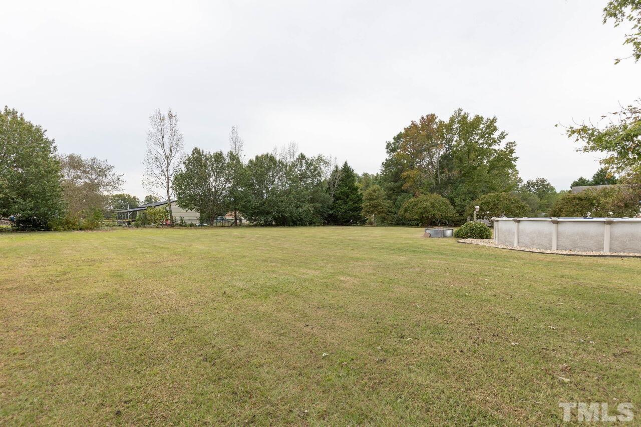 6573 Madison Road Bailey, NC 27807 - Photo 31 of 31 a view of a field with trees in the background