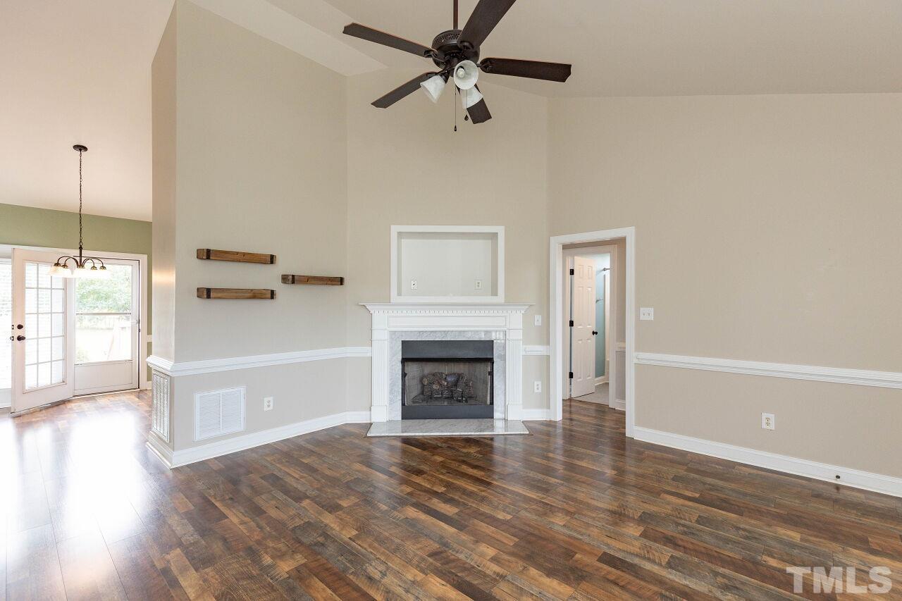 6573 Madison Road Bailey, NC 27807 - Photo 5 of 31 a living room with a fireplace with wooden floor