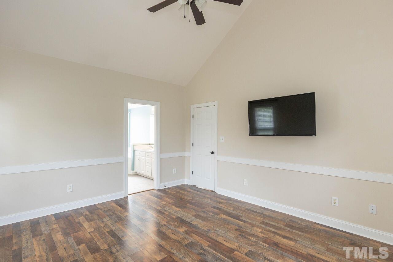 6573 Madison Road Bailey, NC 27807 - Photo 10 of 31 a view of a livingroom with wooden floor and a flat screen tv