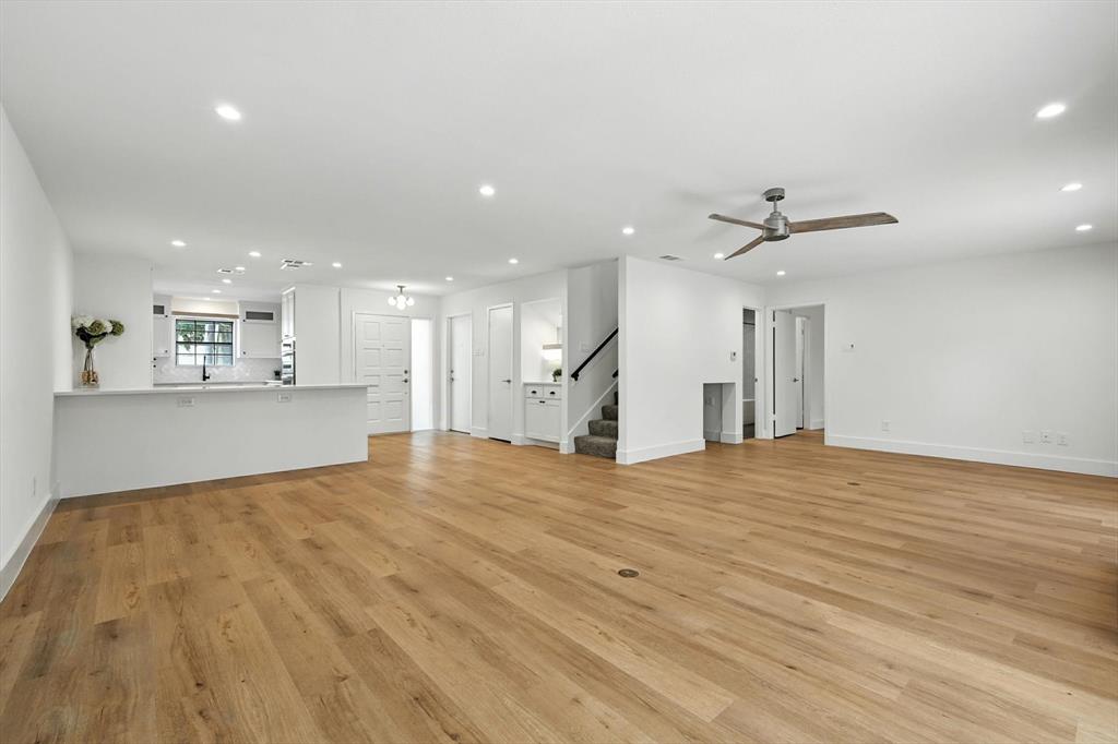 a view of an empty room and kitchen view