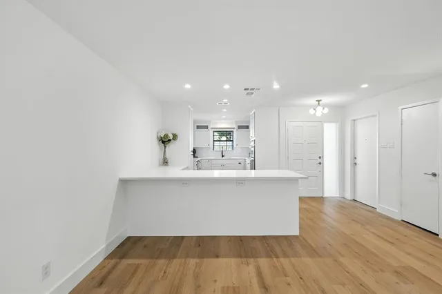a view of kitchen with stainless steel appliances a sink and a refrigerator