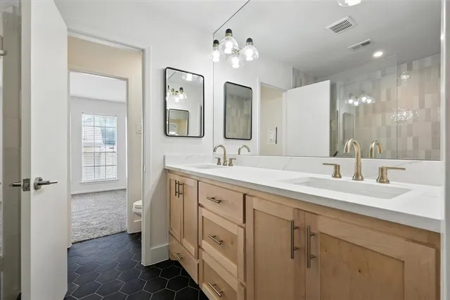 a spacious bathroom with a double vanity sink mirror and double