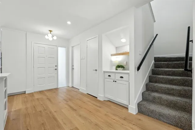 a view of an entryway with wooden floor