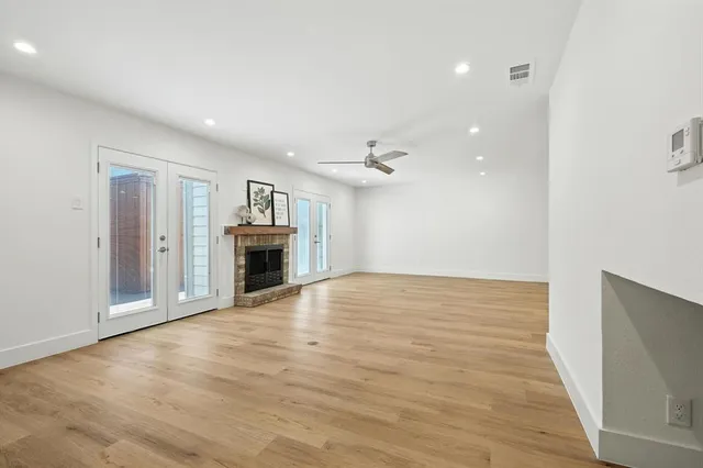 wooden floor in an empty room with a fireplace