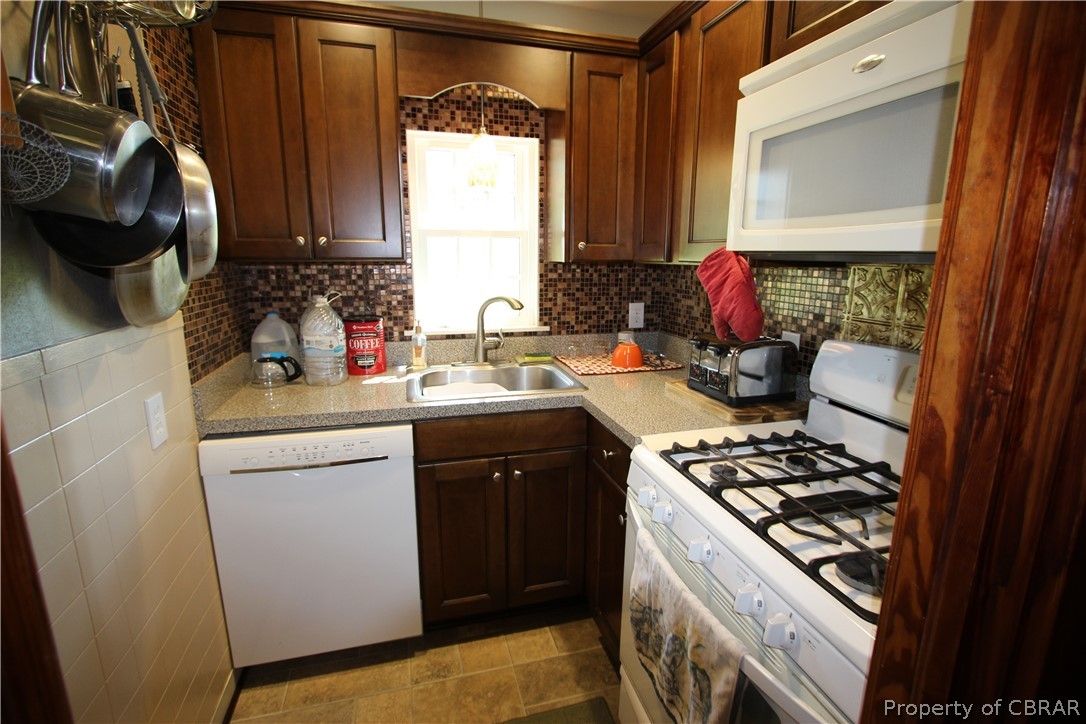 1247 Gdn Crk Road Mathews, VA 23109 - Photo 20 of 49 a kitchen with a sink stove and cabinets