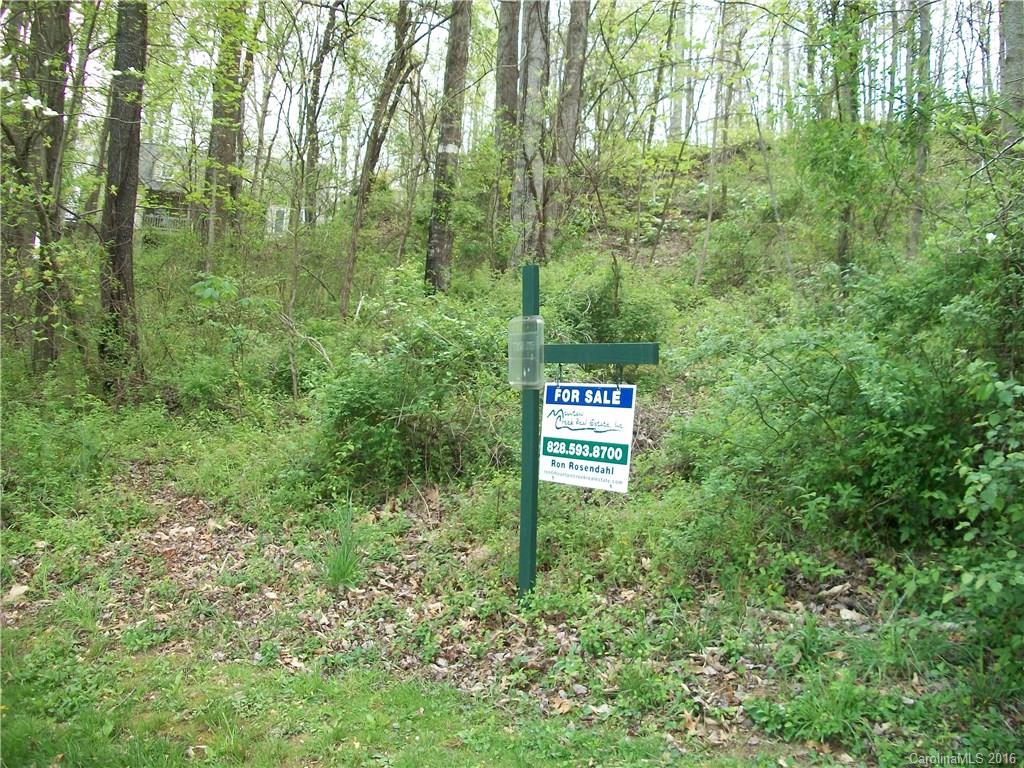 Lot#14 Aldersgate Road, Unit 14 Waynesville, NC 28786 - Photo 12 of 16 a sign that is sitting in front of a forest