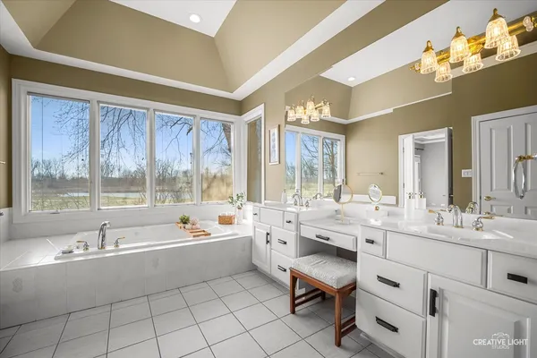 a bathroom with a sink a large mirror and vanity