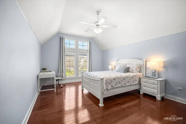 a bedroom with a large bed and a chandelier