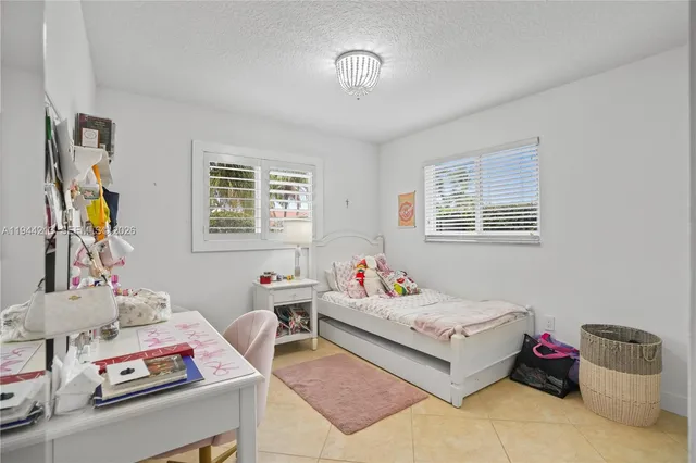 a bedroom with bed and a window