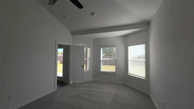 an empty room with windows and closet