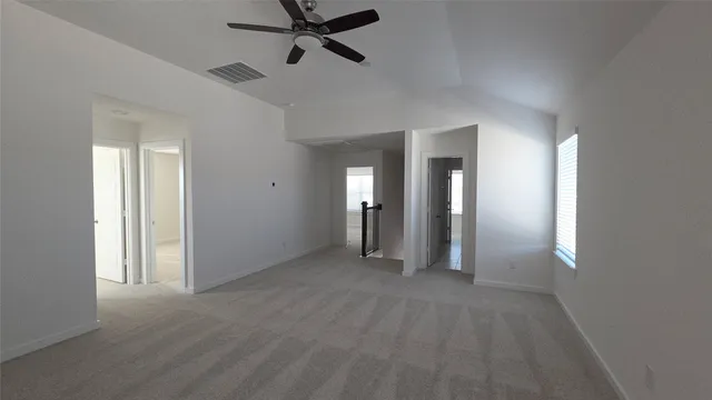 a view of a room with wooden floor and white walls