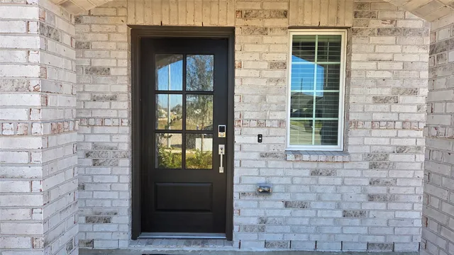 a front view of a brick house with a glass door