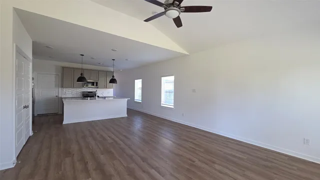 a view of a living room hardwood floor and a ceiling fan
