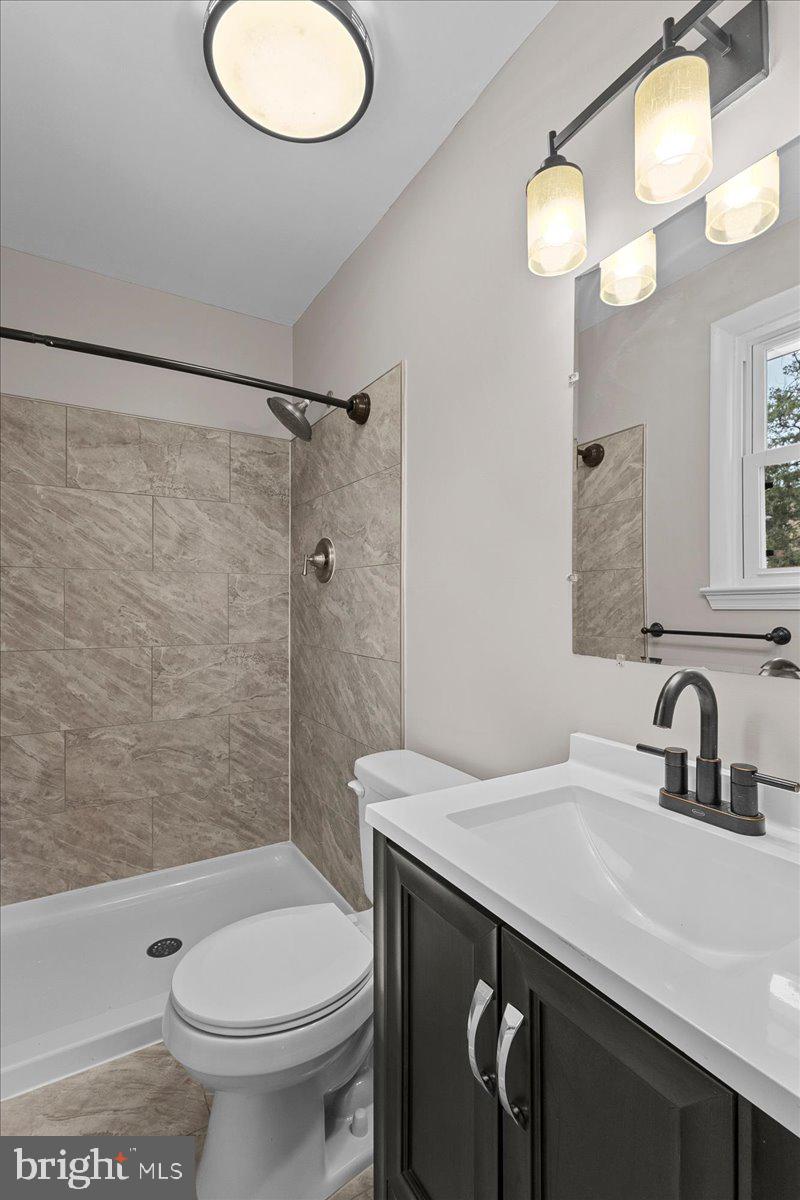 6812 Fulford Street Clinton, MD 20735 - Photo 13 of 32 a bathroom with a sink a toilet and shower