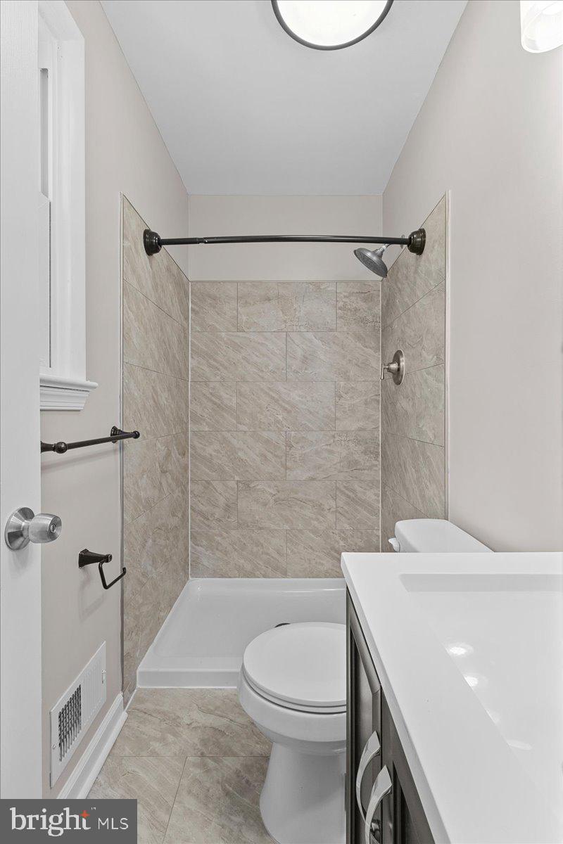 6812 Fulford Street Clinton, MD 20735 - Photo 14 of 32 a bathroom with a sink a toilet and shower
