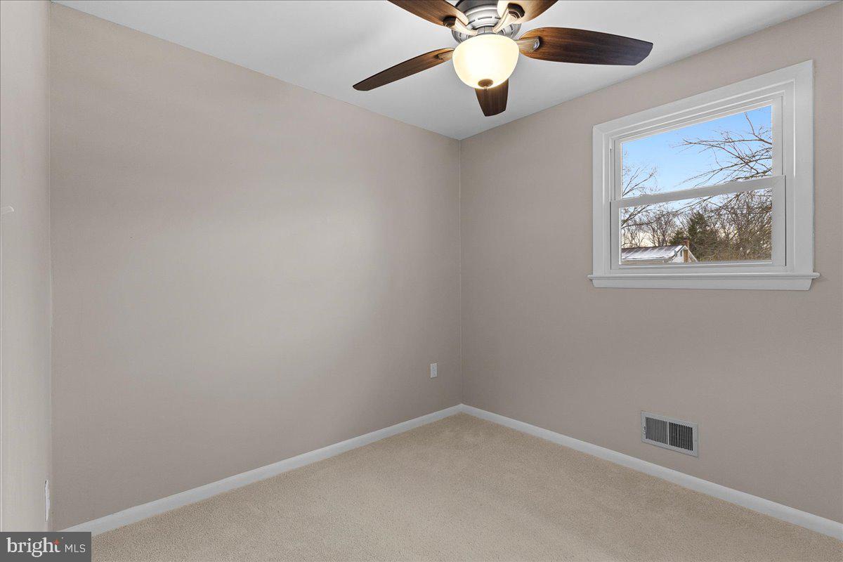 6812 Fulford Street Clinton, MD 20735 - Photo 16 of 32 an empty room with a window and a fan