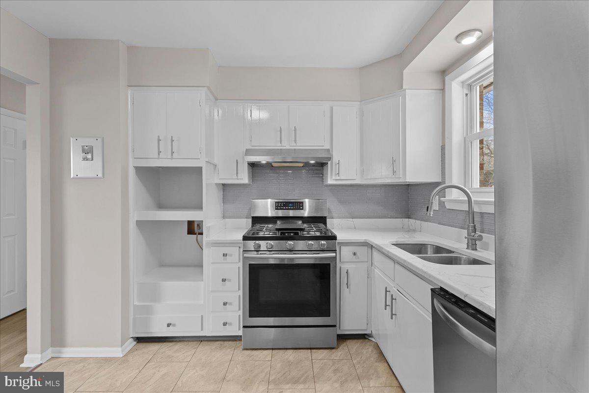 6812 Fulford Street Clinton, MD 20735 - Photo 9 of 32 a kitchen with white cabinets and appliances