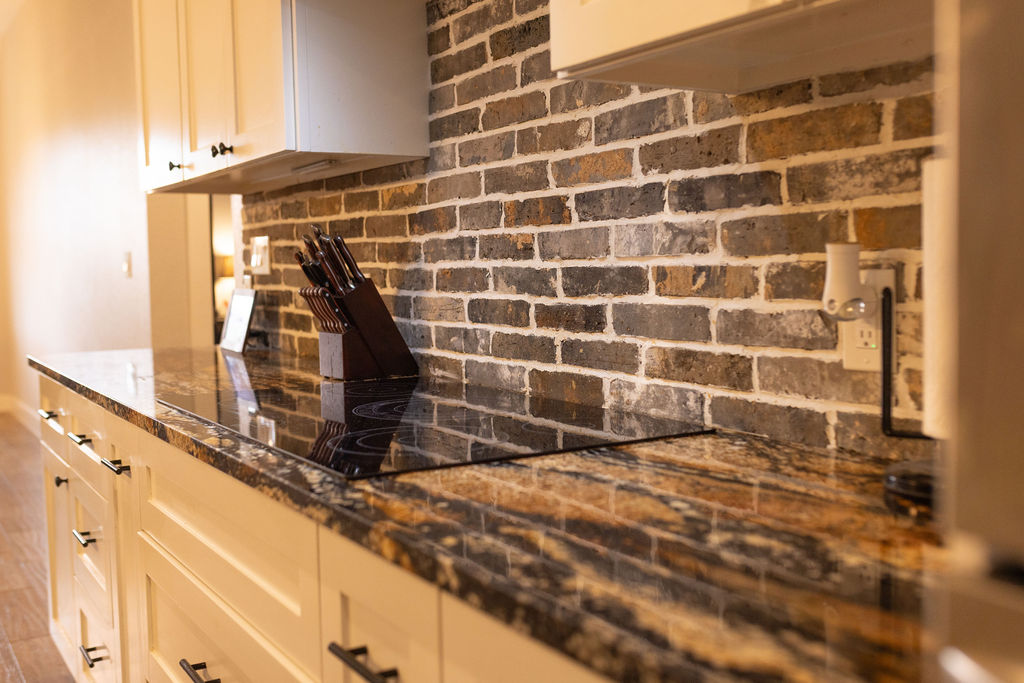 111 Powder Ridge Luling, TX 78648 - Photo 14 of 22 Rich granite countertops and a sleek cooktop enhance this kitchen's appealing design.
