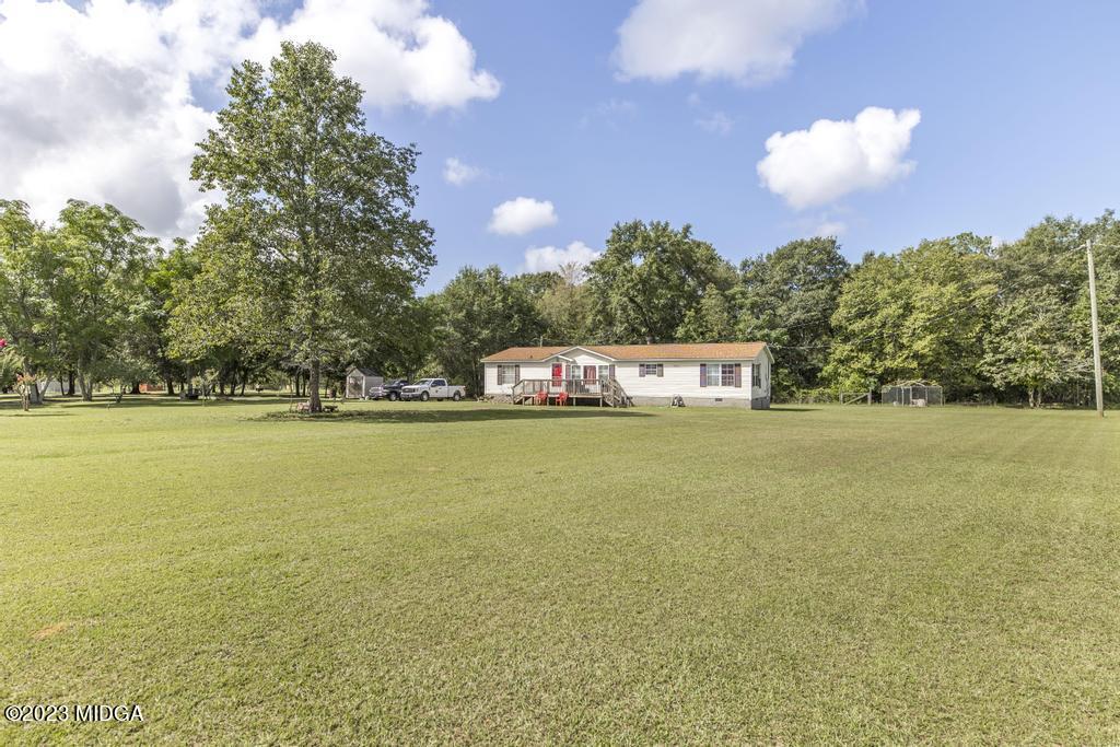 1592 Tribble Road Fort Valley, GA 31030 - Photo 1 of 30 a view of a building with large trees