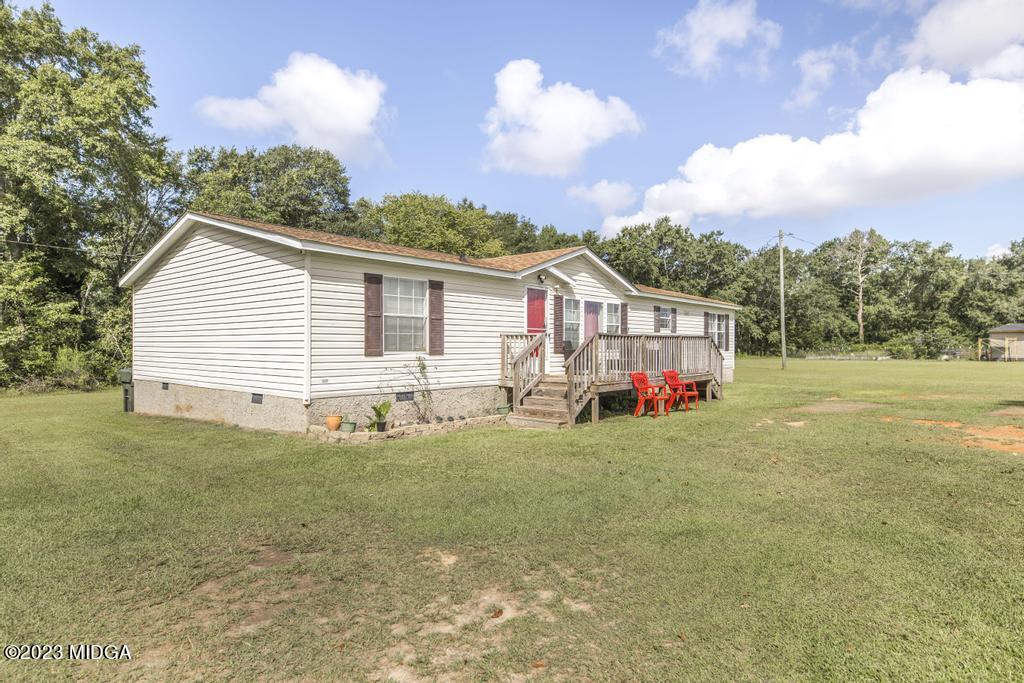 1592 Tribble Road Fort Valley, GA 31030 - Photo 2 of 30 a view of a house with a yard and sitting area