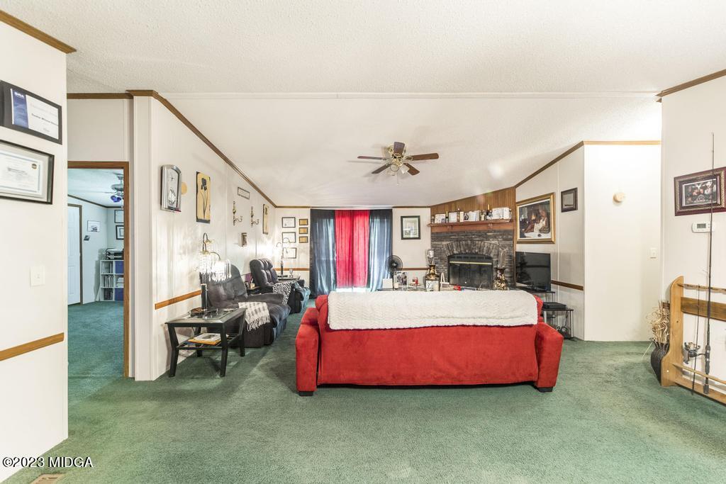 1592 Tribble Road Fort Valley, GA 31030 - Photo 28 of 30 a bedroom with a bed and a chandelier