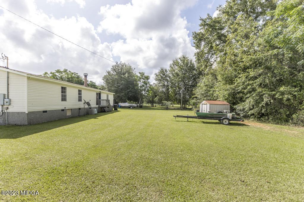 1592 Tribble Road Fort Valley, GA 31030 - Photo 5 of 30 a house view with swimming pool and trees in the background