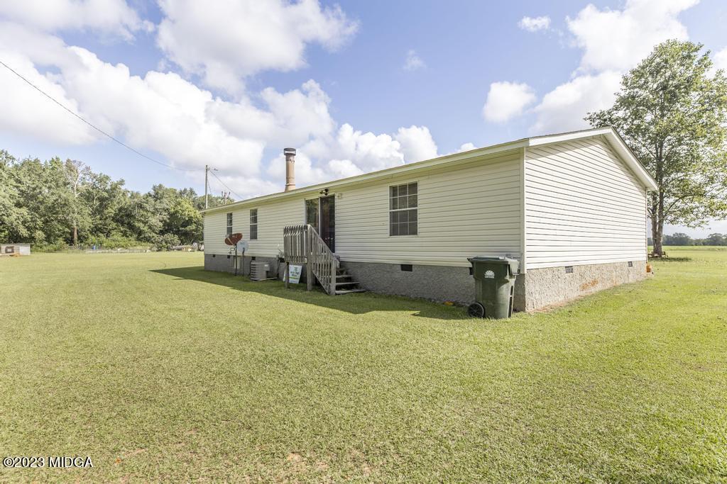1592 Tribble Road Fort Valley, GA 31030 - Photo 7 of 30 a view of a house with backyard and sitting area